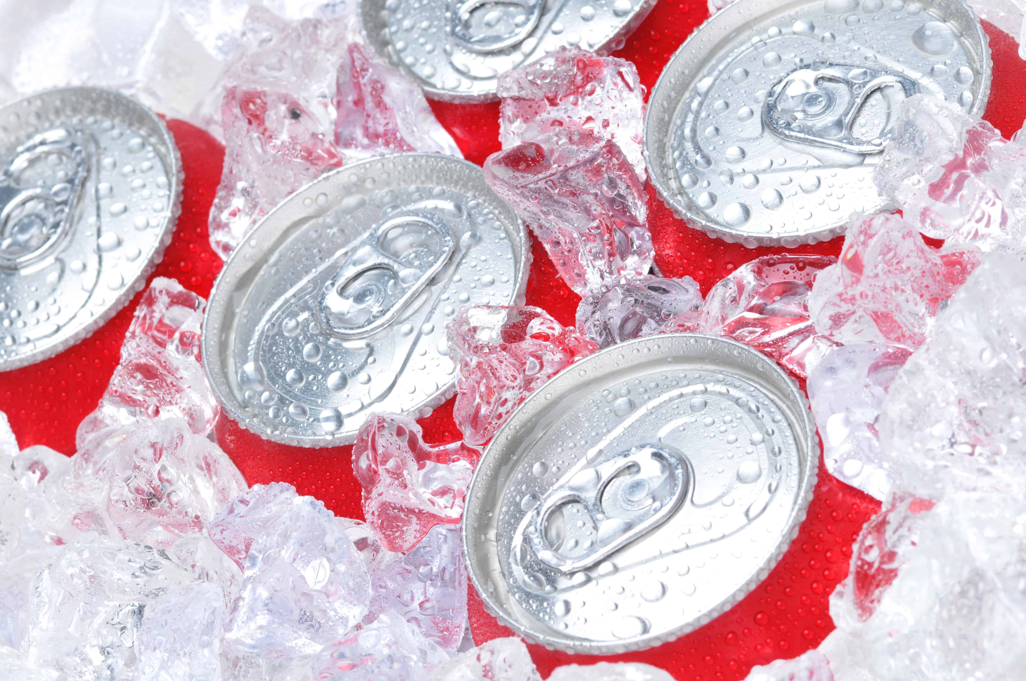 Close Up of Soda Cans in Ice with Condensation
