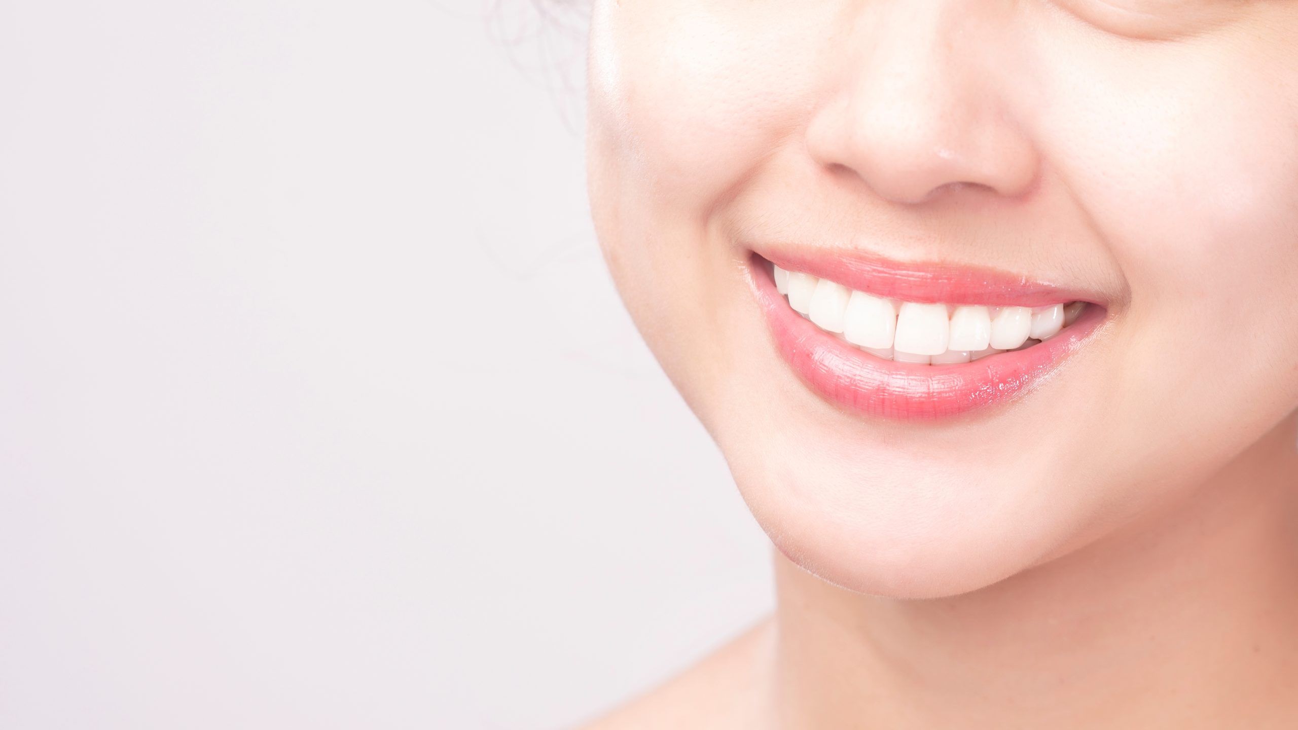Close up of  white healthy teeth of beautiful smile young woman